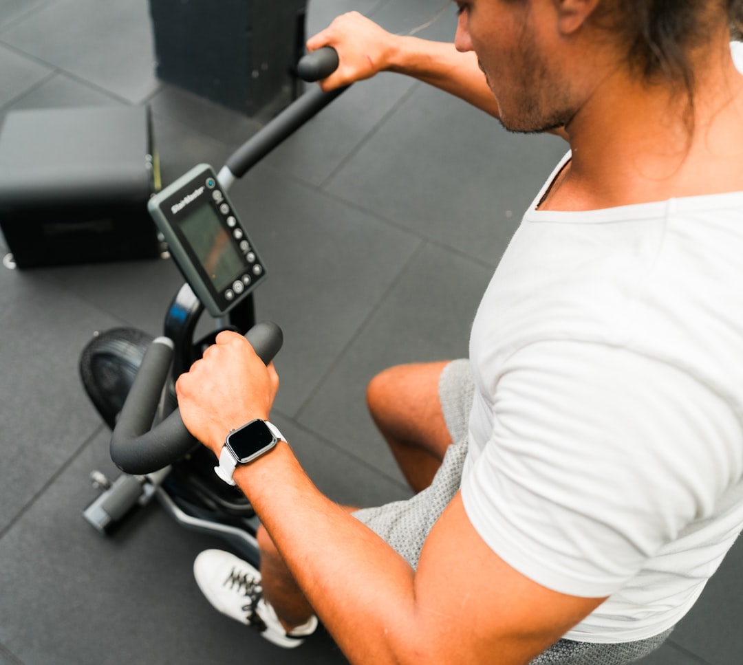 A split image showing an exercise bike on one side and a rowing machine on the other, highlighting their differences in design and usage.