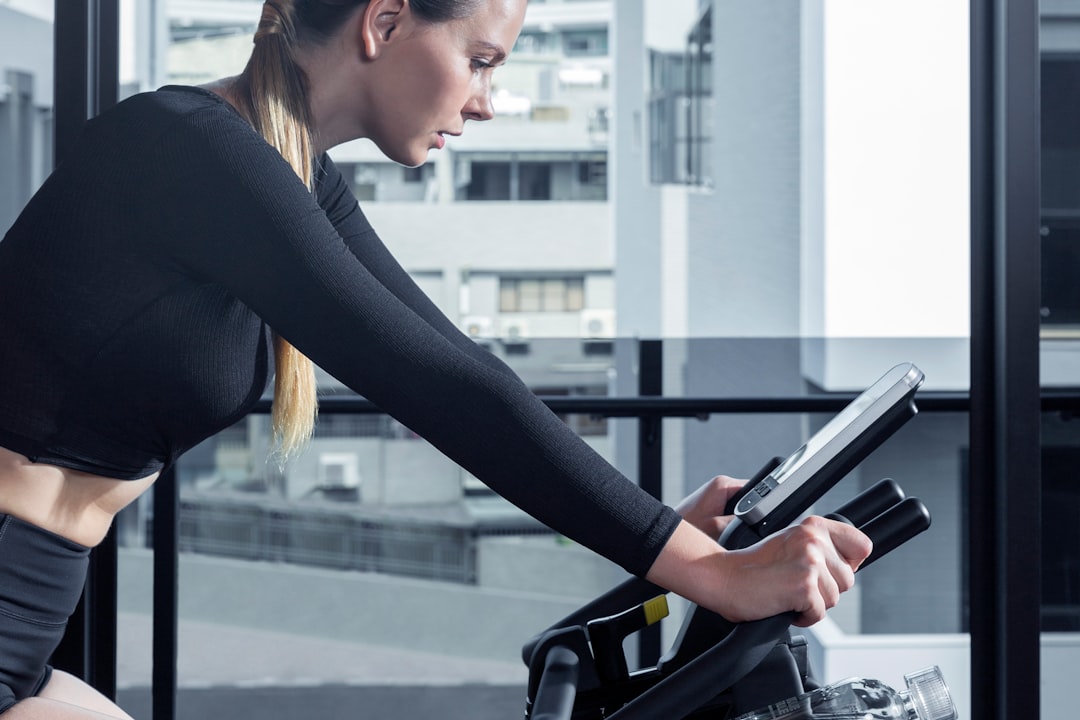 A person using an exercise bike in a bright, modern home gym setting, showcasing fitness and motivation.