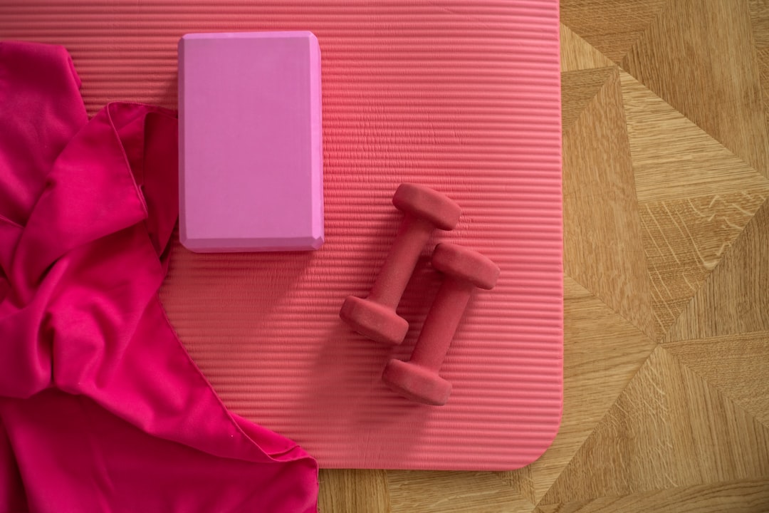 A serene home workout space featuring a yoga mat, plants, and natural light.