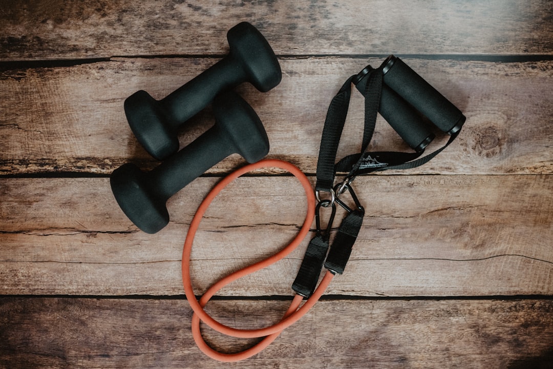 A variety of colorful resistance bands laid out on a gym floor, showcasing different types and sizes for strength training.