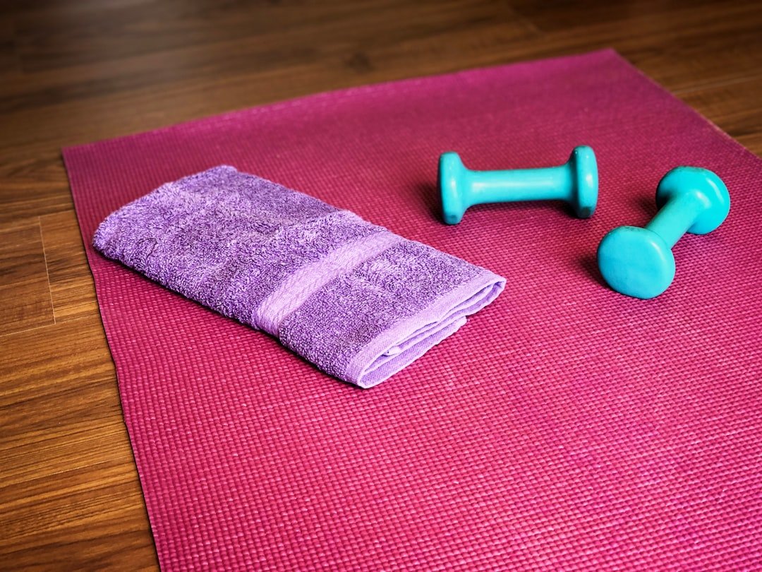 Yoga mat, weights, and a towel ready for a workout